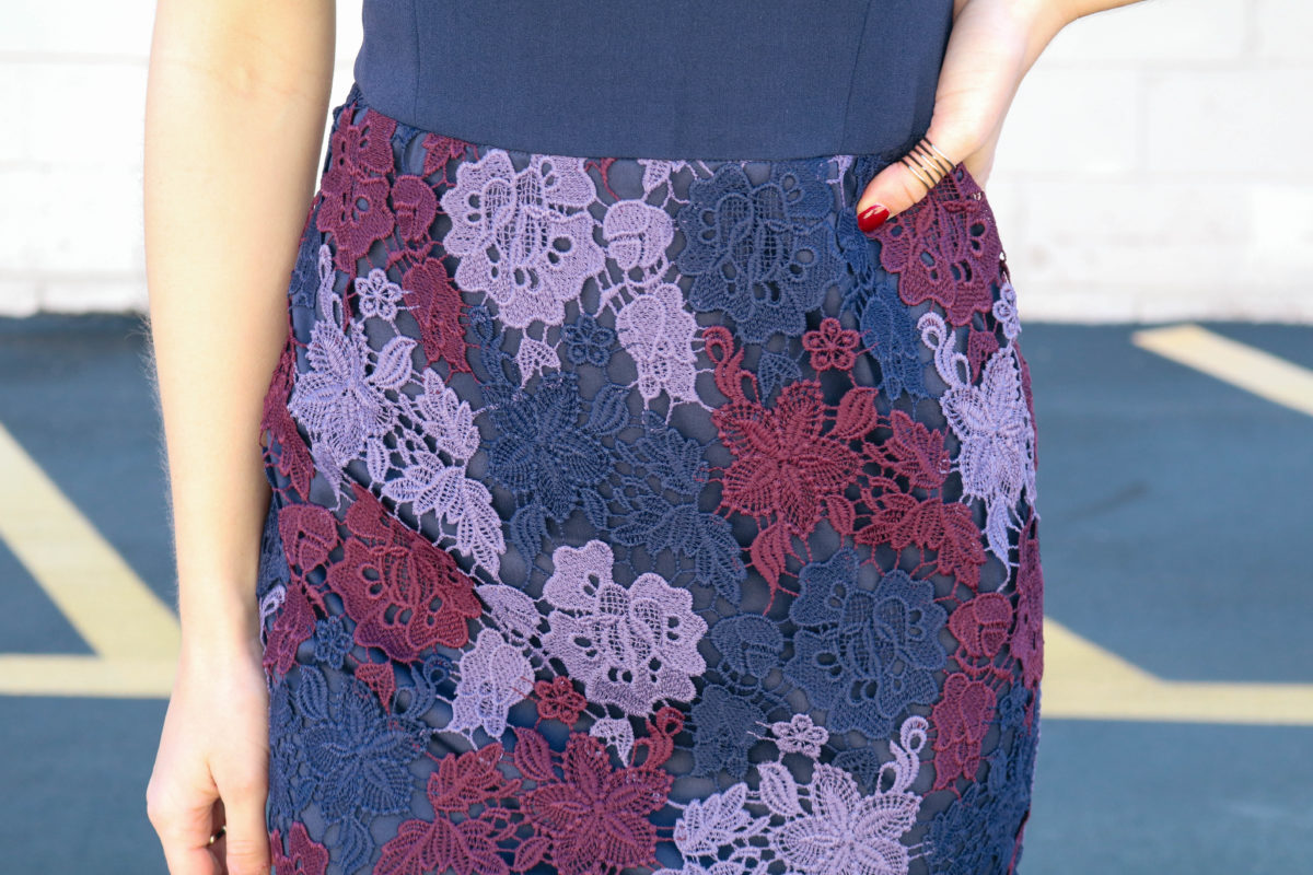 End of November seasonal style with tri-color lace of burgundy, navy and purple embodying the rich hues of autumn as a cinched-waist sheath dress. 