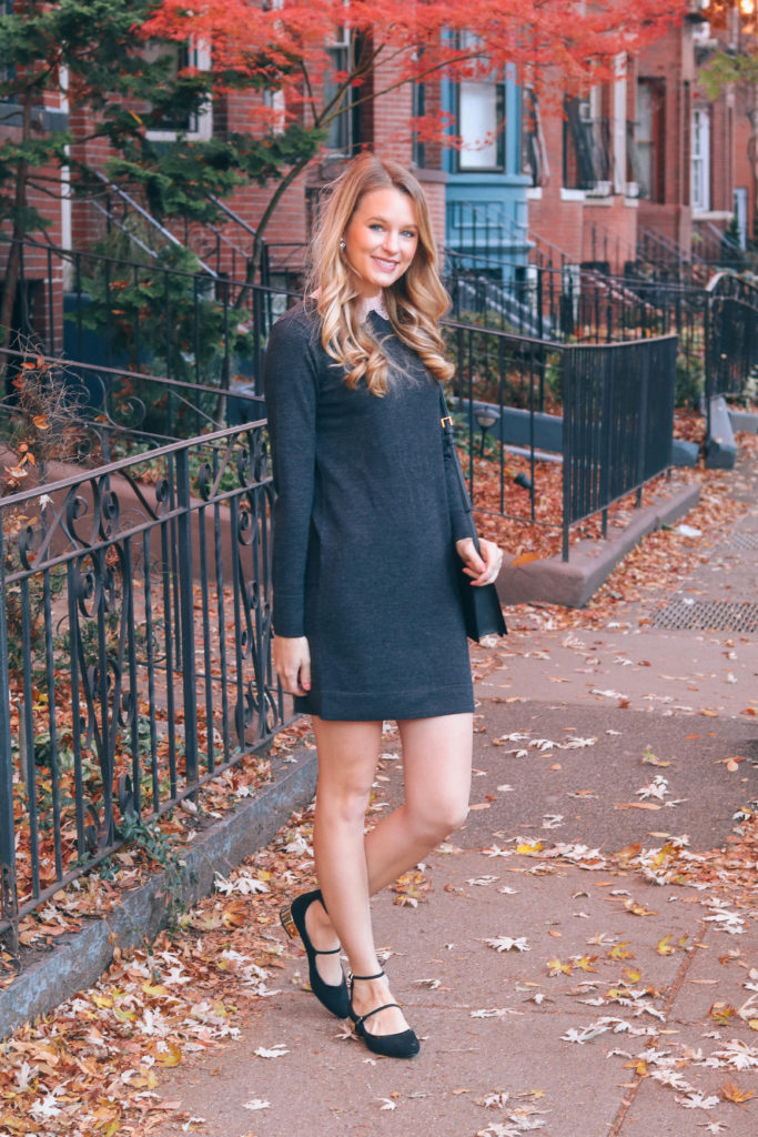 Leigha Gardner of The Lilac Press wearing a charcoal gray sweater dress with a blush lace collar from Club Monaco.