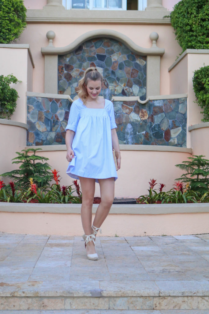 Style blogger, Leigha Gardner, of The Lilac Press twirling around St. Thomas in a little blue dress; showing off shirting material trends for spring.