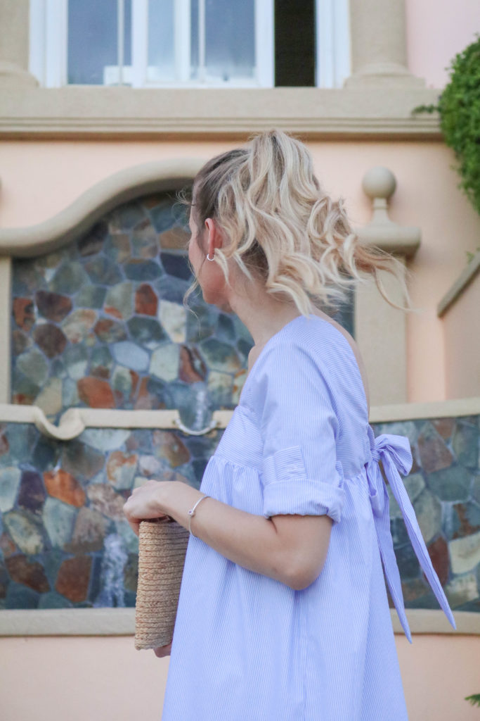 Style blogger, Leigha Gardner, of The Lilac Press twirling around St. Thomas in a little blue dress; showing off shirting material trends for spring.