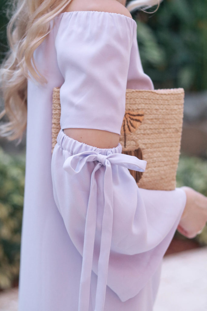 Style blogger, Leigha Gardner, of The Lilac Press wearing a lilac off-the-shoulder dress with bell sleeves and cutouts from Club Monaco.
