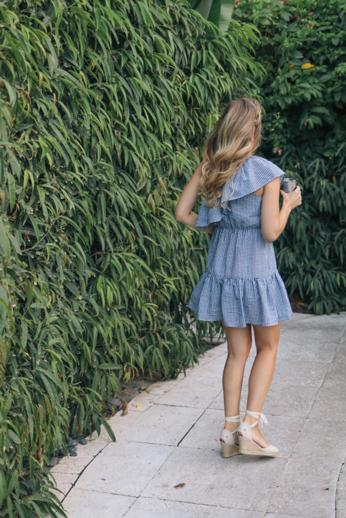 Fashion blogger, Leigha Gardner, of The Lilac Press wearing a blue gingham one-shoulder dress in Miami