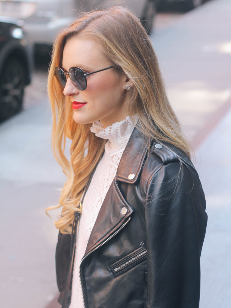Style blogger, Leigha Gardner, of The Lilac Press wearing a white See by Chloe lace dress coupled with a leather jacket in the cobblestone streets of Soho.