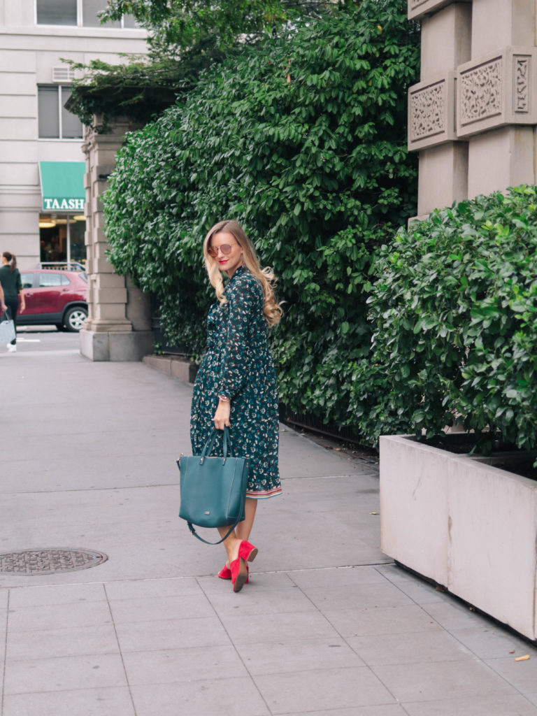Fashion blogger, Leigha Gardner, of The Lilac Press wearing a transitional summer-to-fall outfit featuring of a teal floral Suncoo dress in New York City