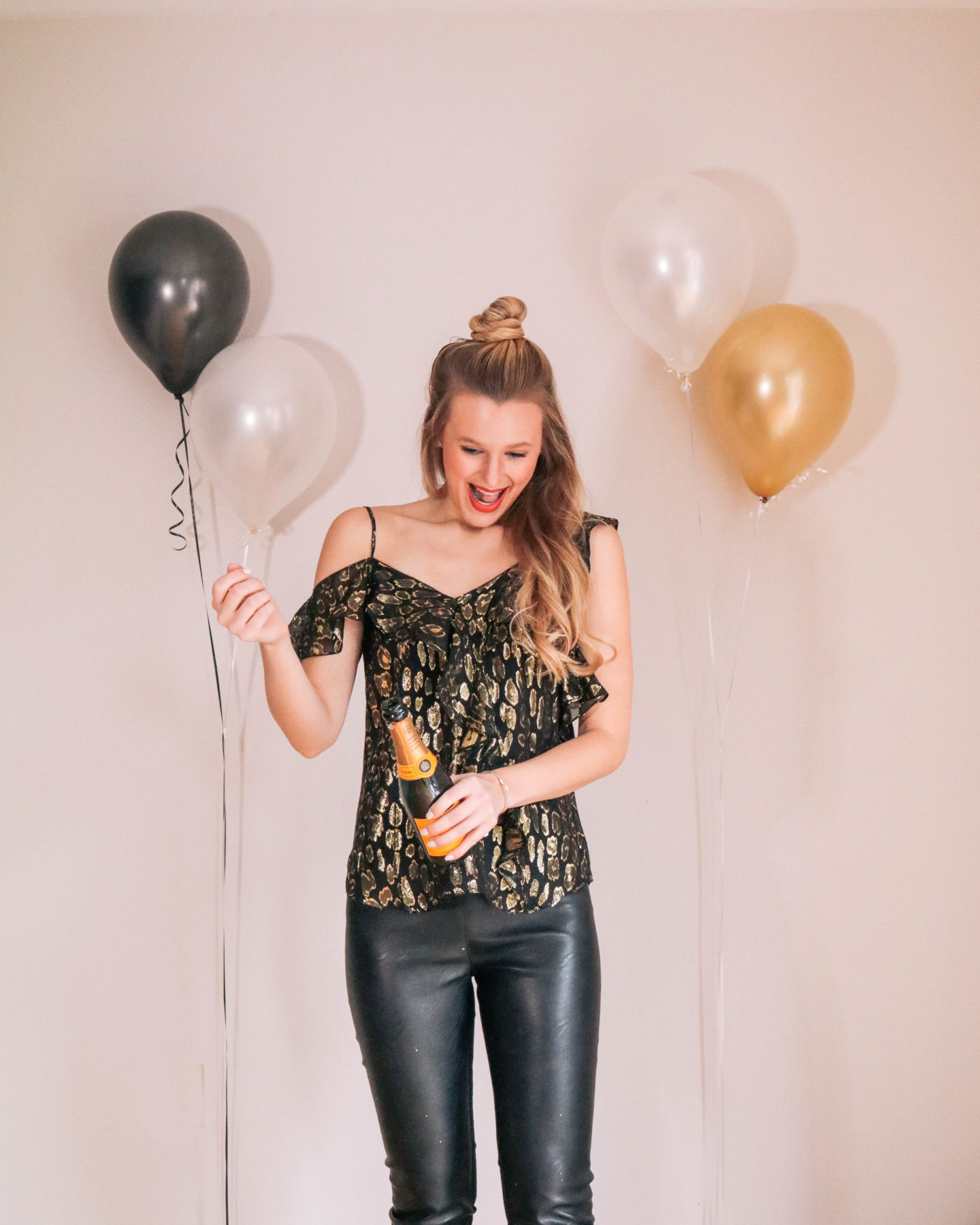 Fashion blogger, Leigha Gardner, of The Lilac Press sharing some designer looks for NYE including this metallic Veronica Beard top and Stella McCartney faux leather leggings.