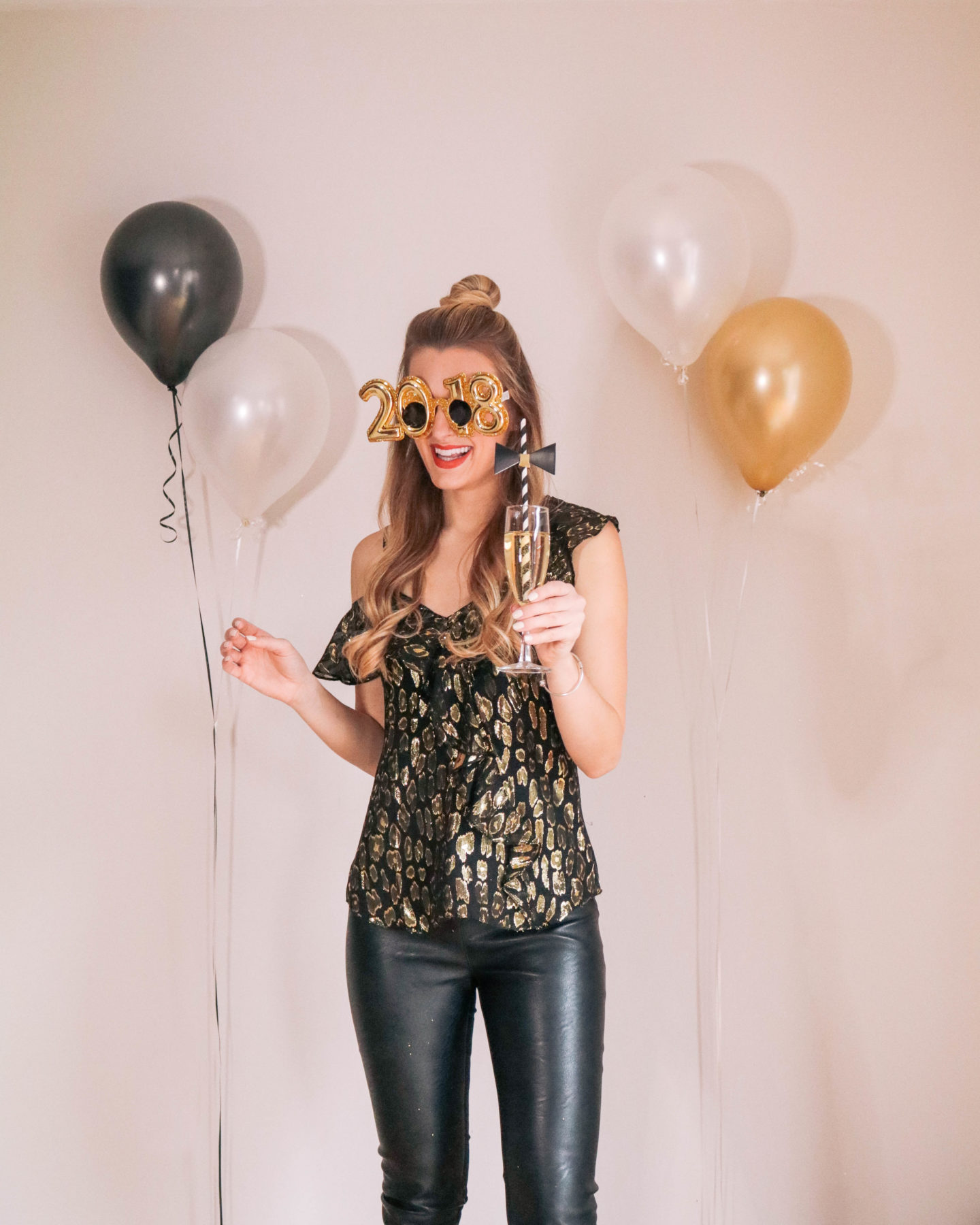 Fashion blogger, Leigha Gardner, of The Lilac Press sharing some designer looks for NYE including this metallic Veronica Beard top and Stella McCartney faux leather leggings.