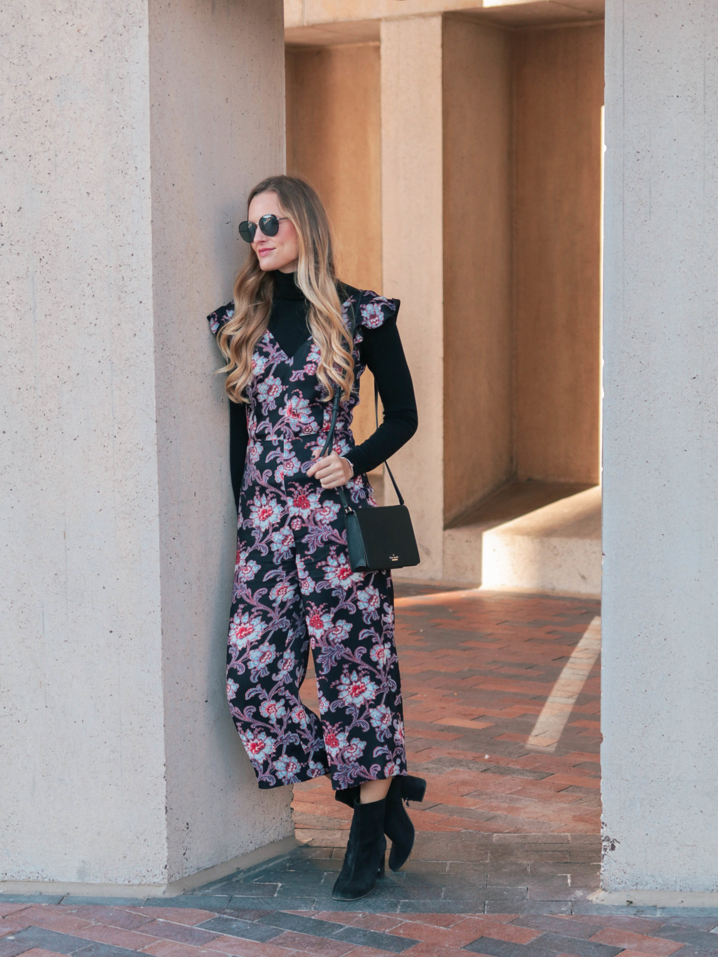 Fashion blogger, Leigha Gardner, of The Lilac Press wearing donning a black turtleneck to transition a floral jumper from warm weather wear to winter wear.