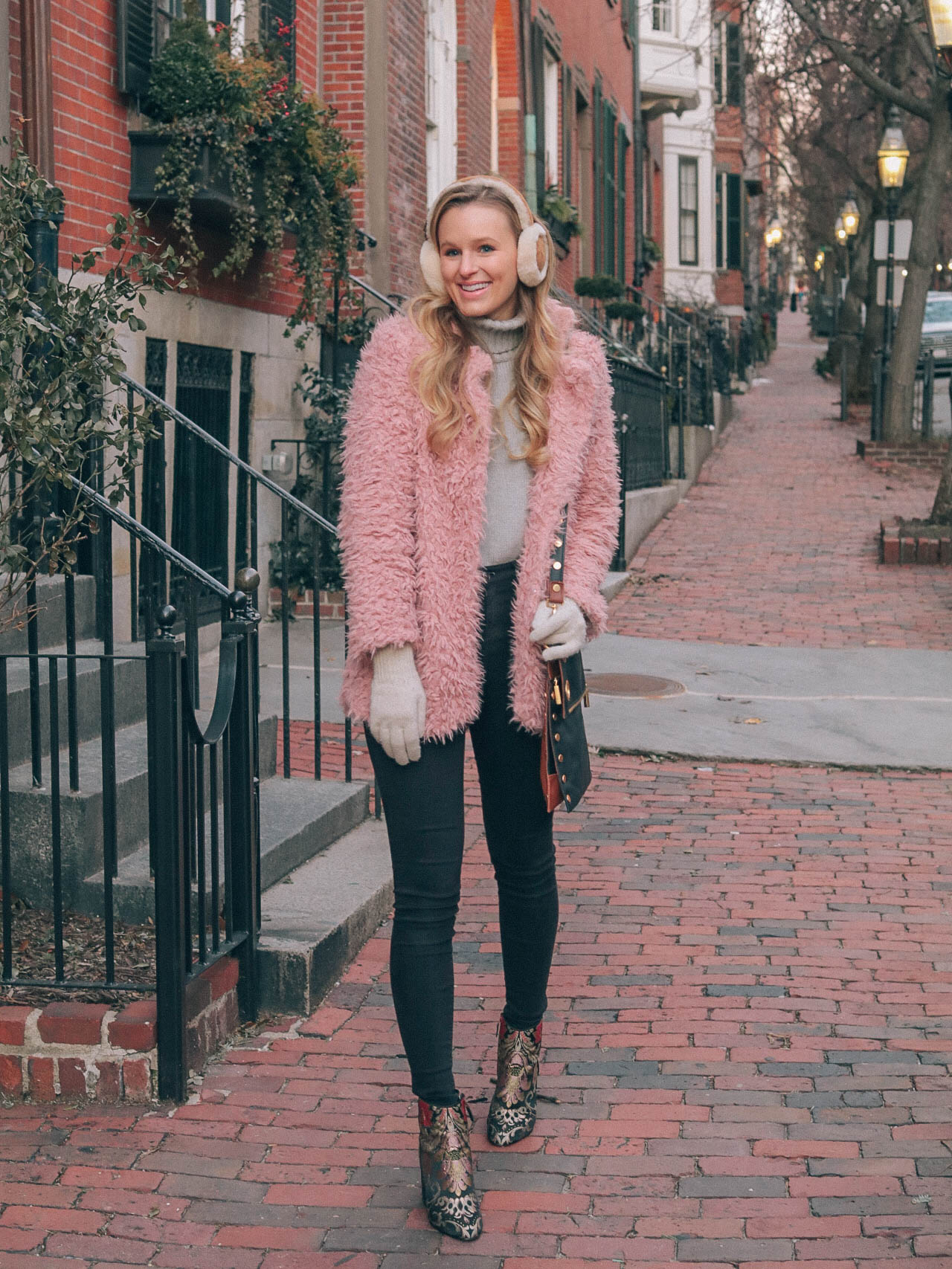 Leigha Gardner, of The Lilac Press, making the most of January in Boston with a pink faux fur coat, embroidered booties and sheepskin earmuffs. 