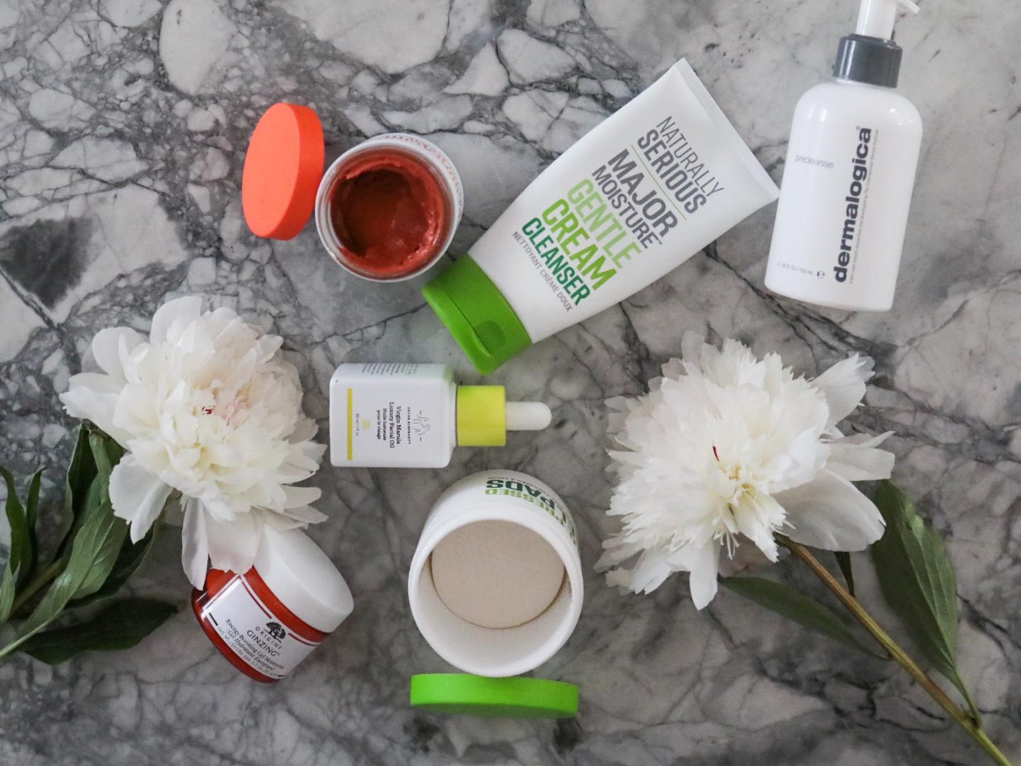 6 skincare revival product picks, featuring Naturally Serious Major Moisture Gentle Cream Cleanser, Drunk Elephant Virgin Marula Oil, Dermalogica Precleanse, Origins Ginzing, Naturally Serious Cold Pressed Peel Pads, Naturally Serious Fruit-tox