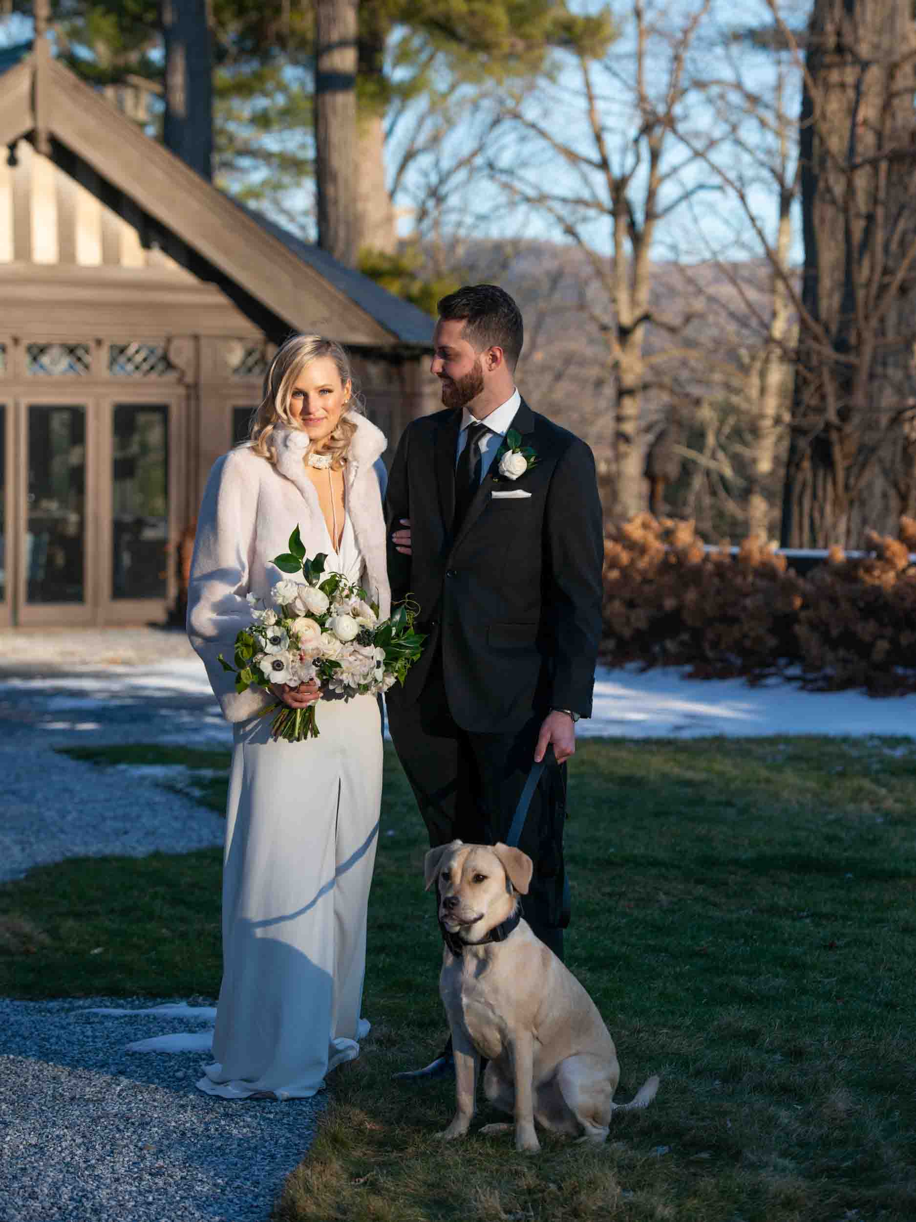 Bride and groom winter wedding portraits at golden hour with puppy