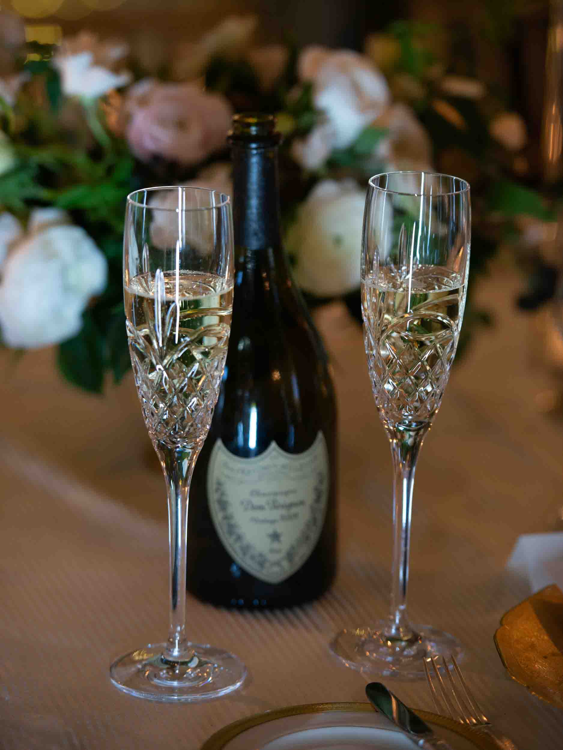 Crystal champagne flutes for bride and groom and Dom Perignon champagne