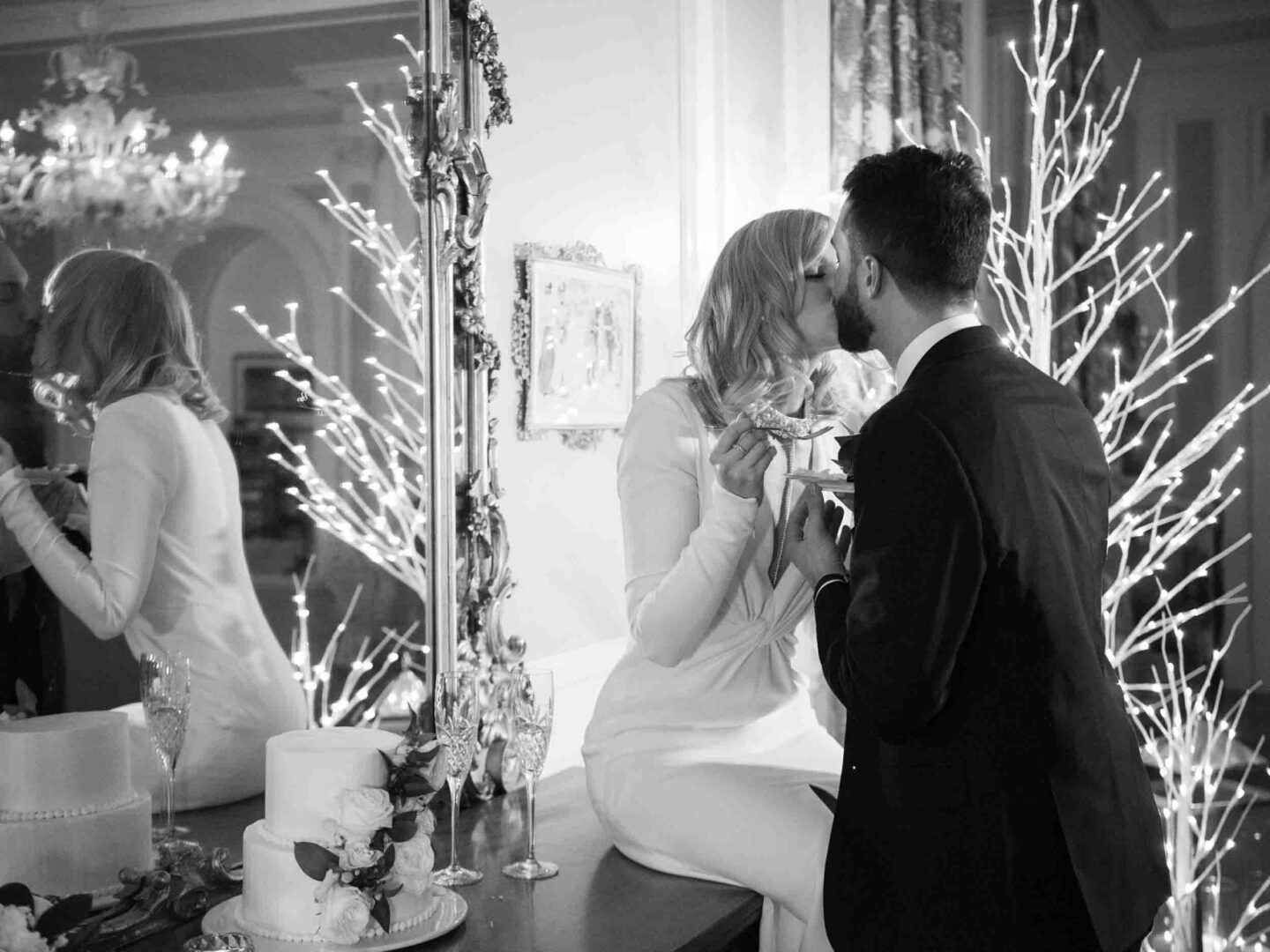 Bride and groom kissing after tasting the cake